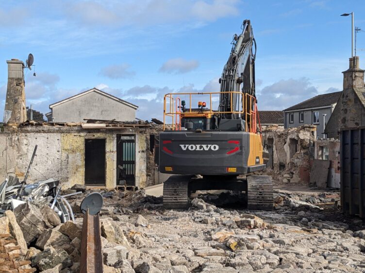 Demolition crew at rear of home. 