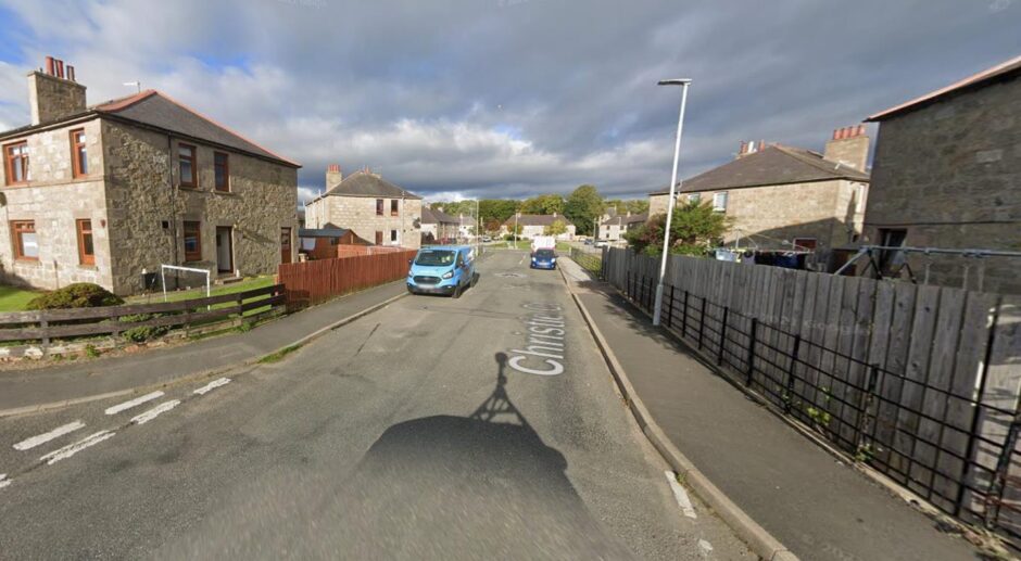 Cars and vans parked on Christie Court, Huntly