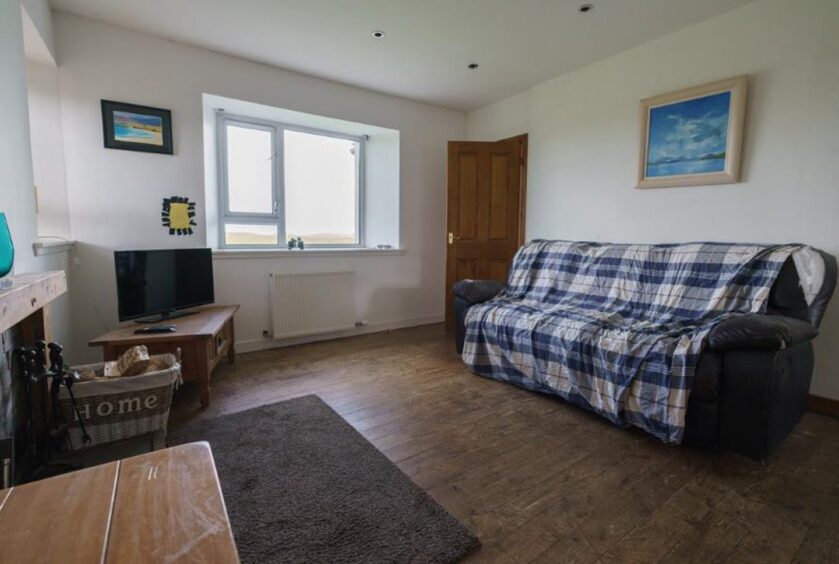 Large living room with views overlooking the sea and rural setting.