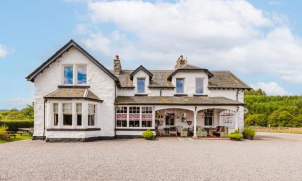 The Whitebridge Hotel surrounded by trees and the blue sky