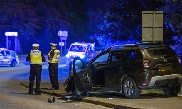 Police called to crash at Turriff, picture shows a damaged car on the roadside.