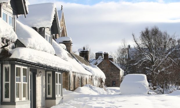 A parked car in snow covered Castleton Terrace in Braemar, Aberdeenshire, which had an overnight temperature of minus 23.0C (minus 9.4F). The village,  which is near Balmoral Castle, the summer residence of Queen Elizabeth II, recorded the lowest temperature in the UK in more than two decades, following an "extreme freeze". Picture date: Thursday February 11, 2021. PA Photo. Forecasters said the last time a temperature below minus 20C was recorded in the UK was December 23 2010. See PA story WEATHER Winter. Photo credit should read: Jane Barlow/PA Wire