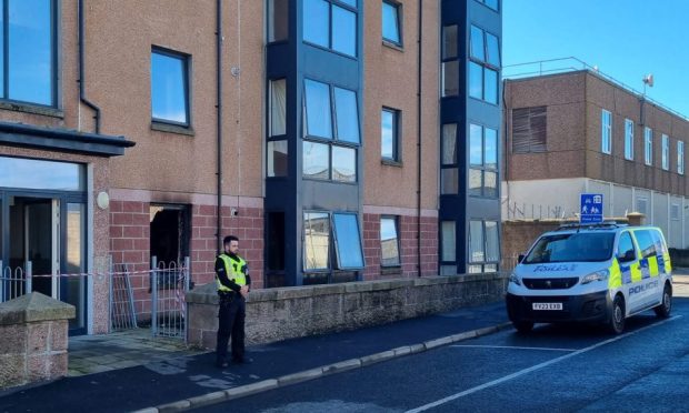 A police officer at the scene of the blaze in King Street, Peterhead. Image: DC Thomson.