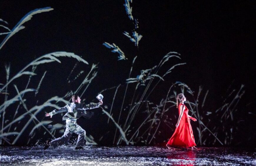 dancers on a dark stage.