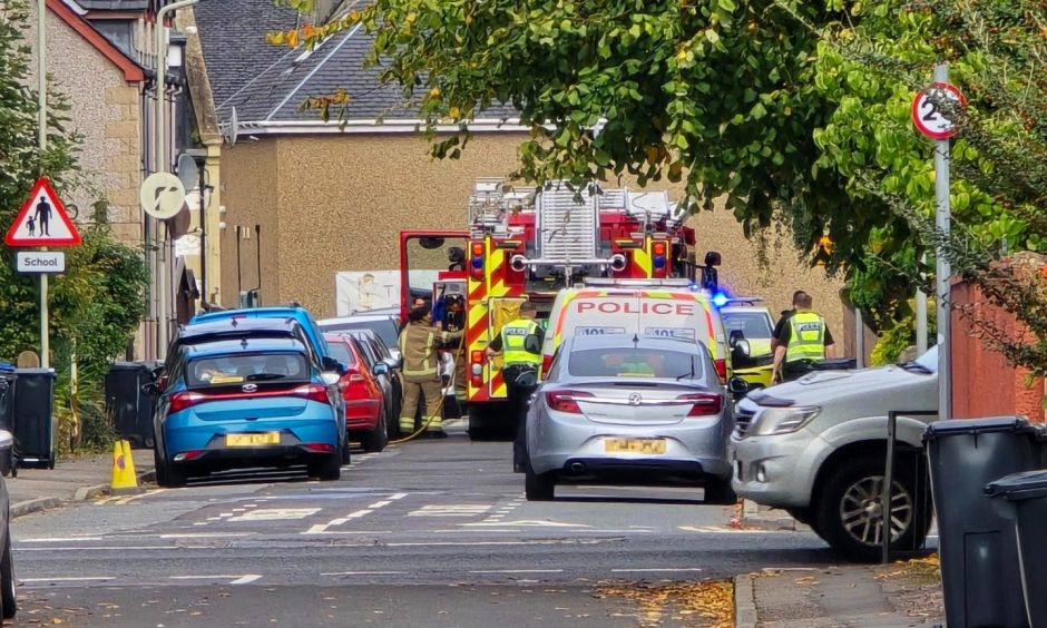 Police and fire engine on residential street in Inverness.