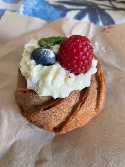 Yevheniia Khmara and Mariia Shcherbar are serving a fresh fruit and cream cheese muffin