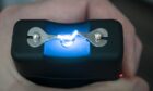 The use of a stun gun with a powerful electric discharge. Personal taser for protection against bandits is in the hands. . Turning on the device for self-defense. View from above