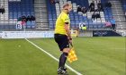 Caley Thistle fan Jamie MacKinnon, who stepped in as linesman after an injury to referee Stewart Luke in the 1-1 draw with Cove Rangers. Image: David Balfour.