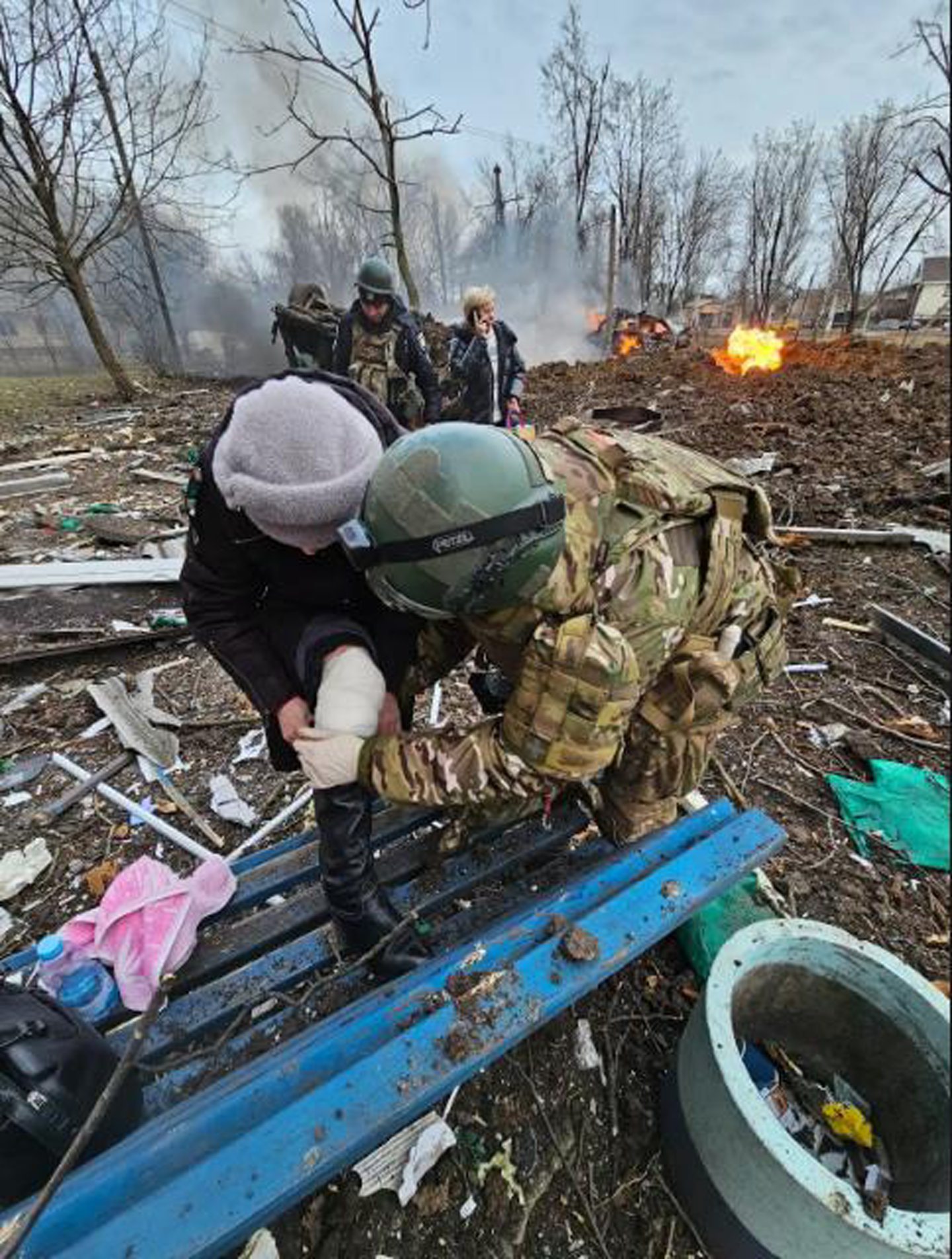 A woman receives treatment following a missile strike 