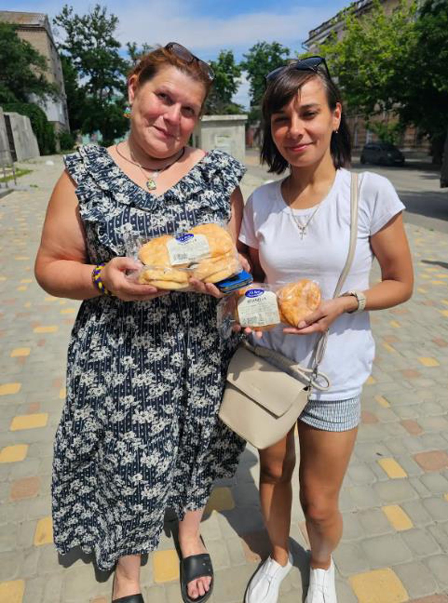 Two women holding butteries