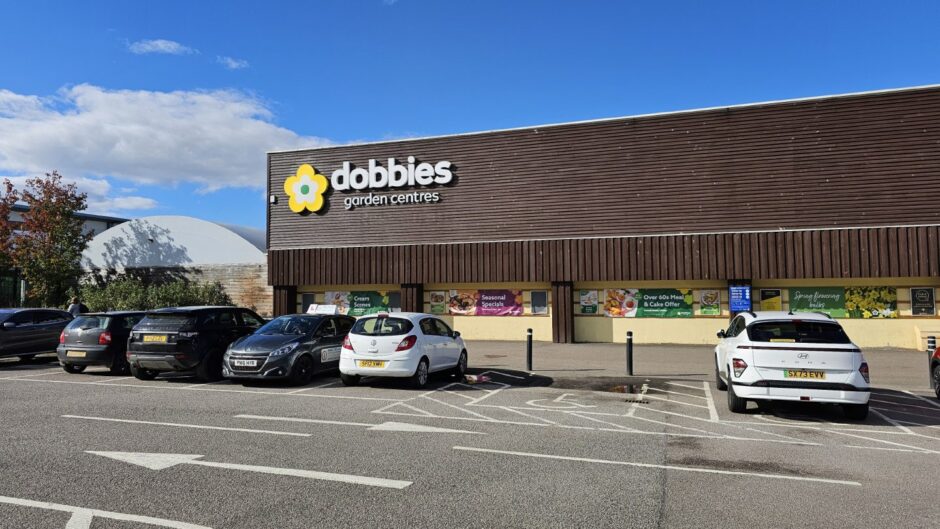 Cars parked down the side of Inverness Dobbies store.