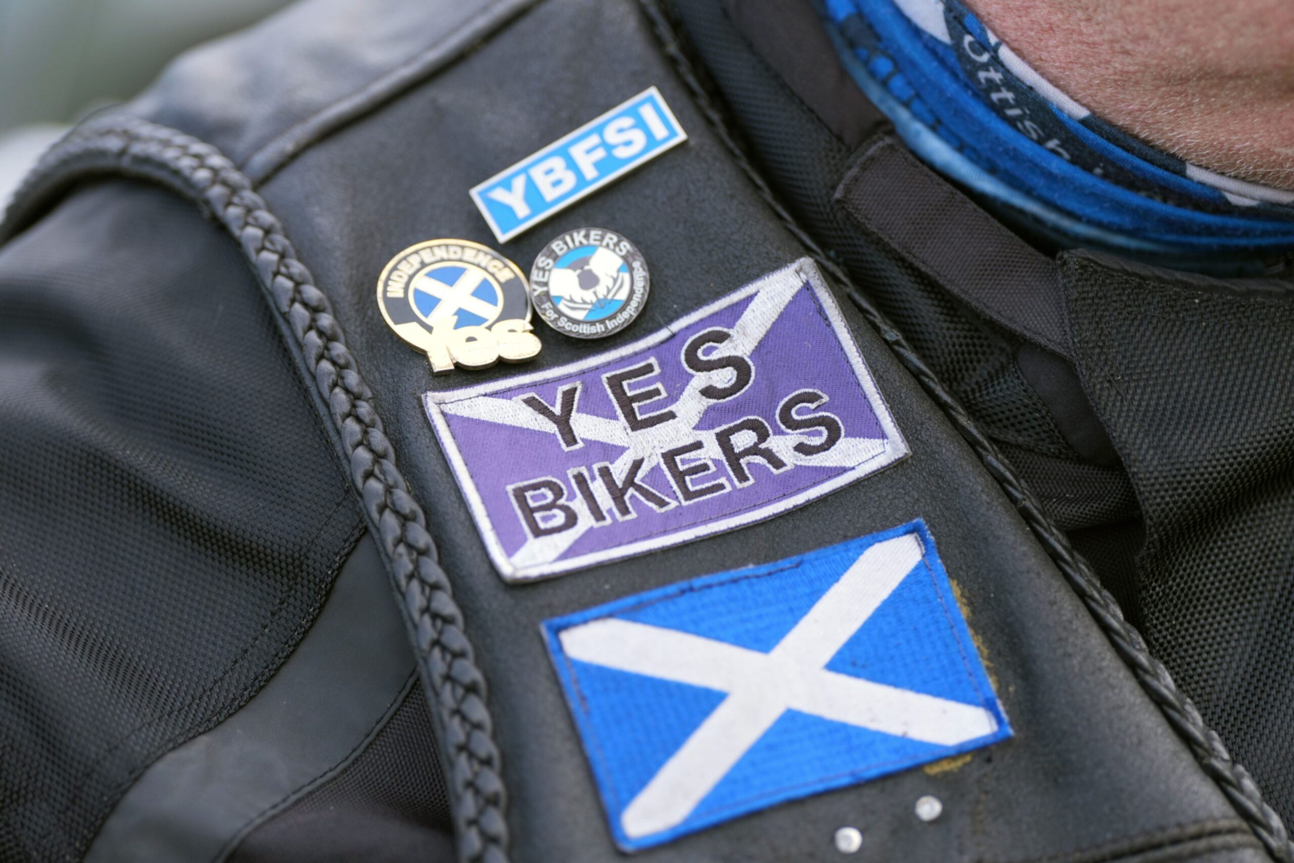 Yes campaign patches and badges being worn by a biker who was there for Alex Salmond's hearse when it returned to Scotland