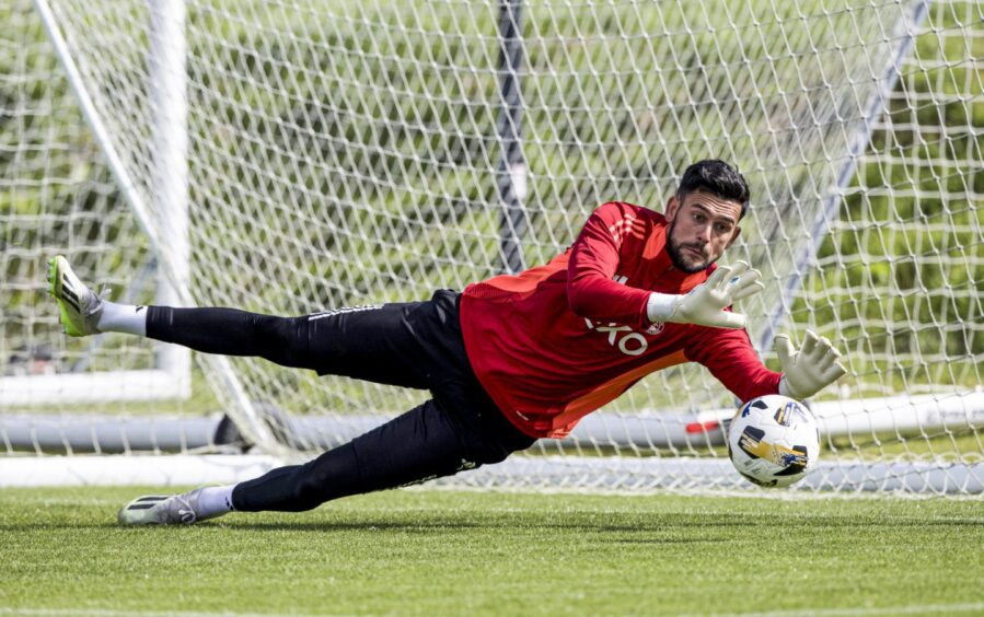 Dimitar Mitov makes a long and low reach to the side to make a save during an Aberdeen training session at Cormack Park, on August 22, 2024. Image: SNS.