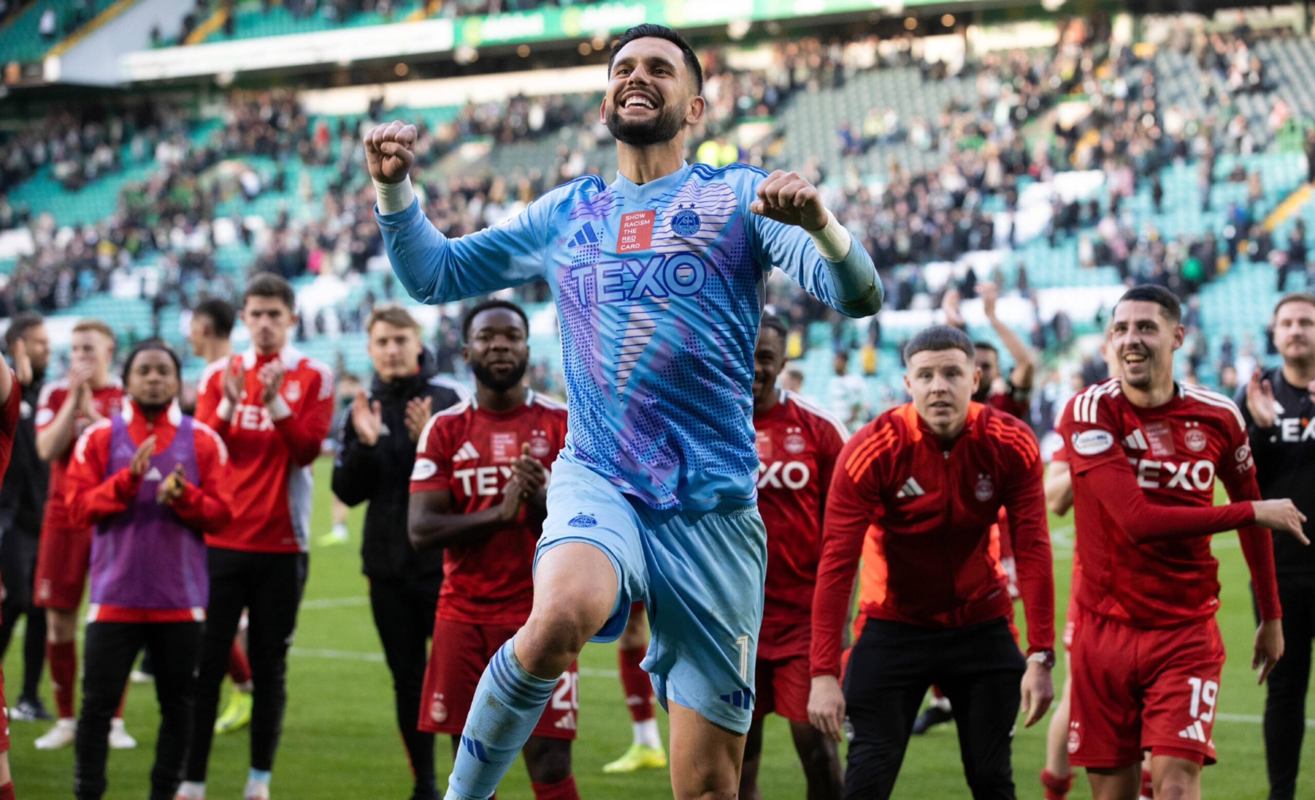 Aberdeen's Dimitar Mitov celebrates at full time after the 2-2 draw with Celtic at Parkhead. Image: SNS 