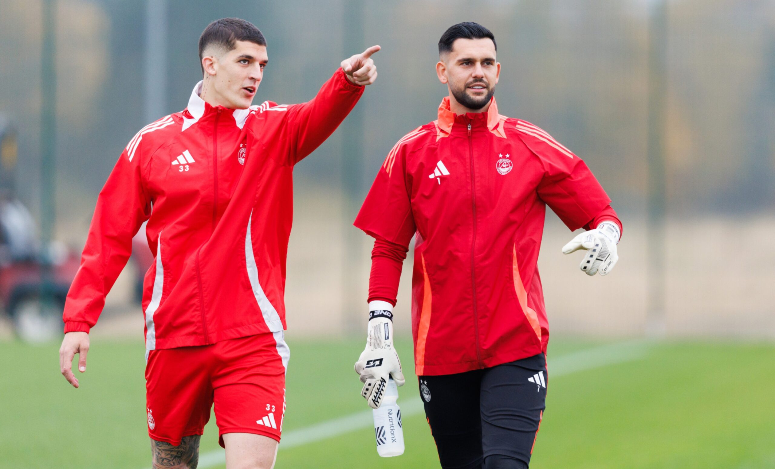 Slobodan Rubezic (L) and Dimitar Mitov (R) during an Aberdeen training session at Cormack Park ahead of the game against Dundee United. Image: SNS 