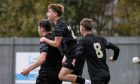 Adam Mackinnon (right) and Keith Bray (centre) celebrate following Jake Davidson's goal against Dumbarton. Image: SNS.