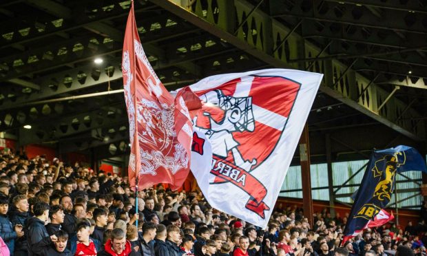 Aberdeen fans wave large flags during a William Hill Premiership match between Aberdeen and Dundee United at Pittodrie.