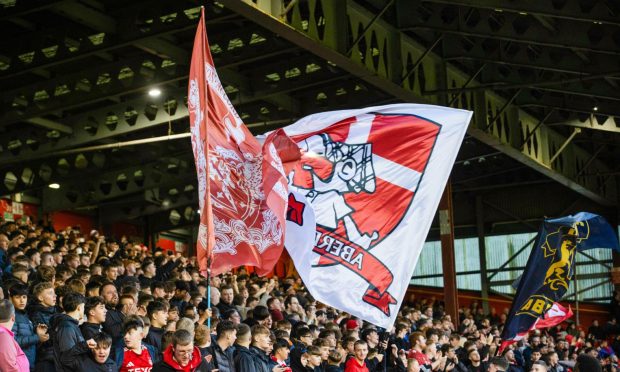 Aberdeen fans wave large flags during a William Hill Premiership match between Aberdeen and Dundee United at Pittodrie.