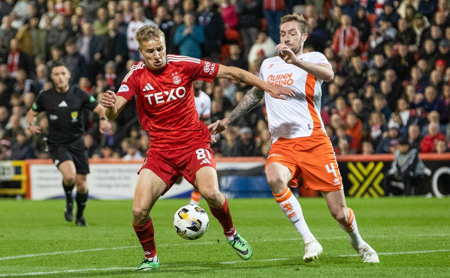 Aberdeen's Topi Keskinen and Dundee United's Kevin Holt in action in a Premiership clash at Pittodrie. Image; SNS