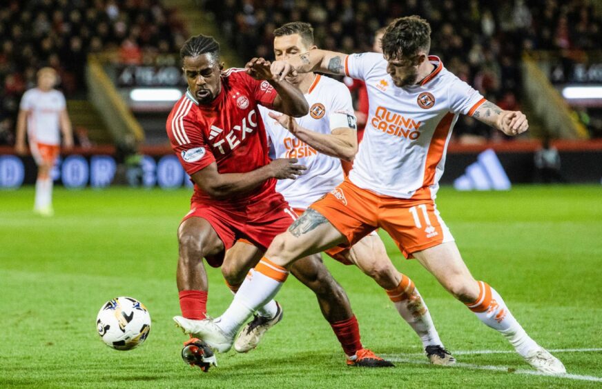 Aberdeen attacker Duk and Dundee United's Ryan Strain tussle for the ball at a sell-out Pittodrie. Image: SNS