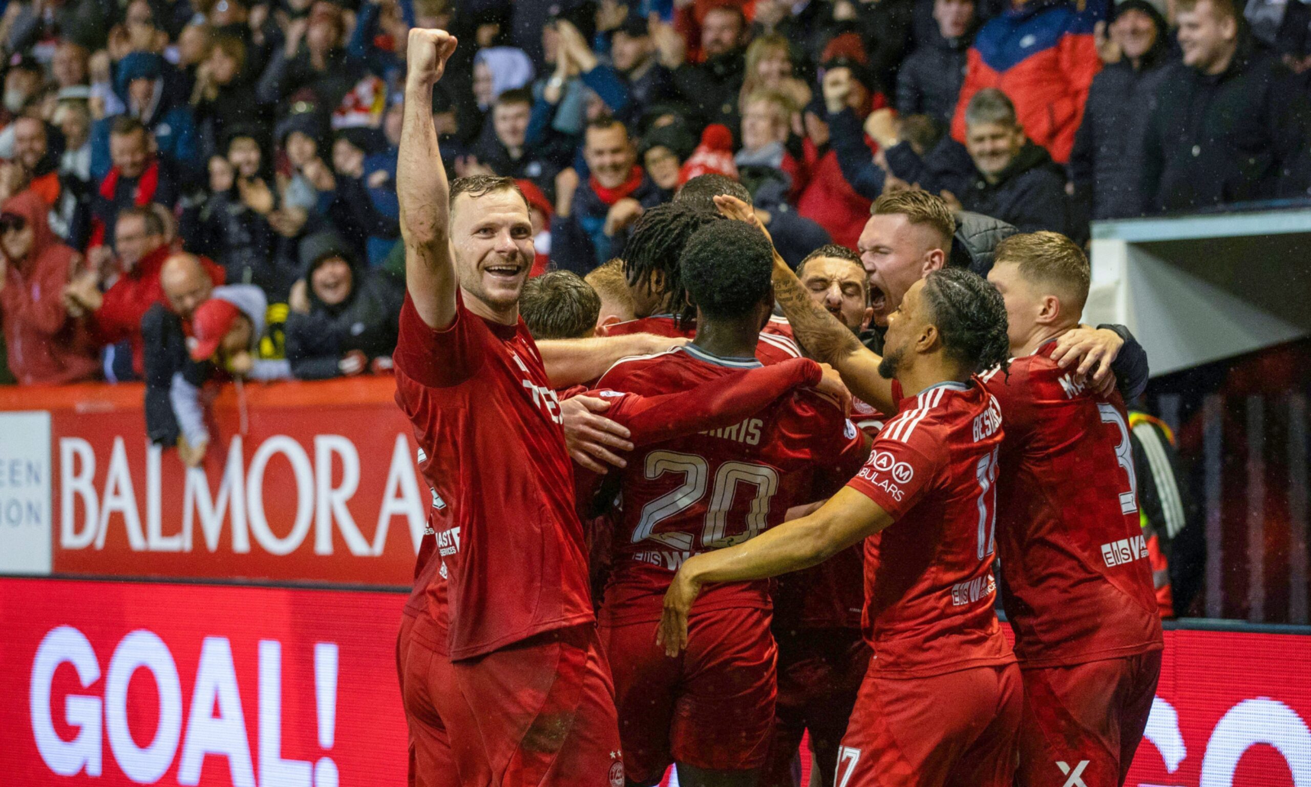 Aberdeen's Nicky Devlin salutes the home fans as Peter Ambrose celebrates with team-mates after scoring to make it 1-0 against Dundee United. Image: SNS