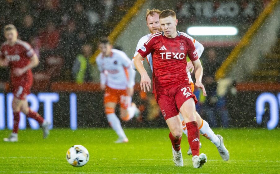 Aberdeen's Gavin Molloy and Dundee United's Jort van der Sande in action during the 1-0 Dons win at Pittodrie last term. Image: SNS 