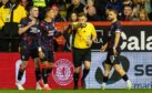 Referee John Beaton gives a penalty to Aberdeen for a handball against John Souttar after a VAR review. Image: SNS.