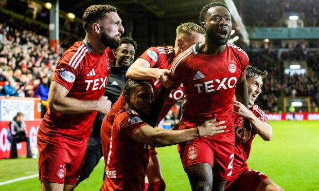 Aberdeen players celebrating the goal that led to their victory against Rangers