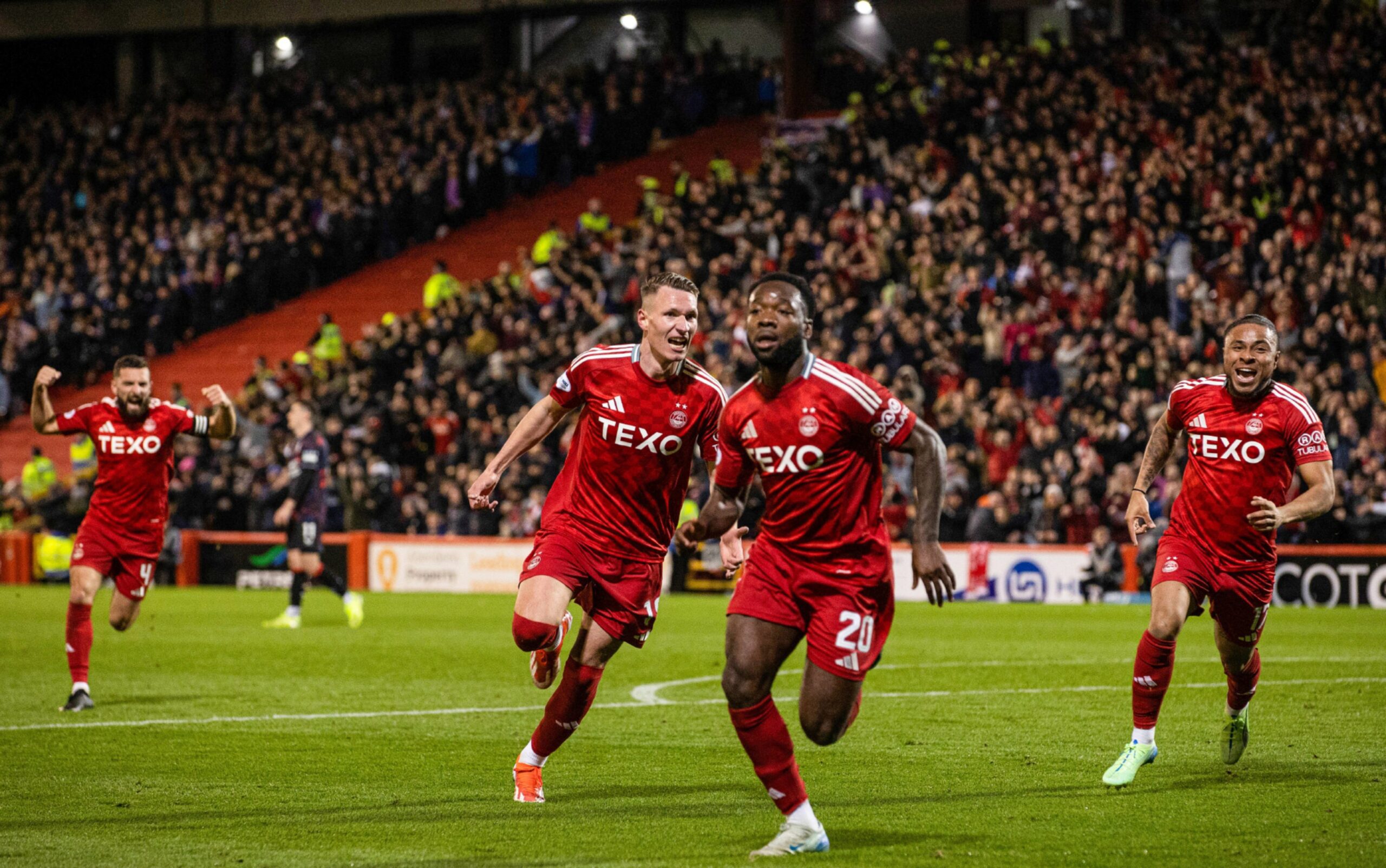 Aberdeen's Shayden Morris celebrates with Ante Palaversa and Vicente Besuijen as he scores to make it 2-1 against Rangers. Image: SNS 