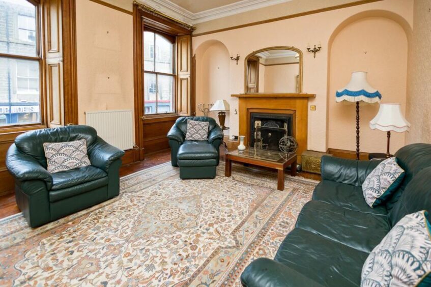 The lounge has retains several original features and boasts original wooden floor.