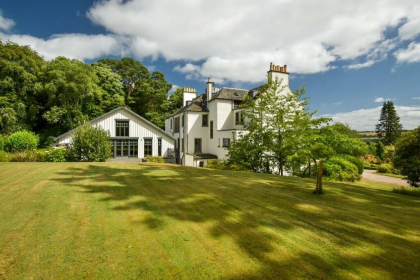 To the left is the large barn extension at the back of the mansion. 