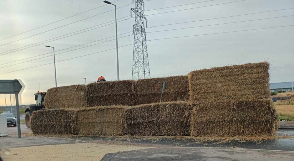 Hay bales piled on A96.