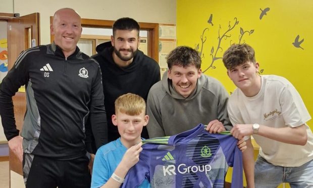 From left to right, Derek Soutar, Balint Demus, Nick Suman and Jack Robertson visiting Adam in hospital. Image: Cove Rangers FC