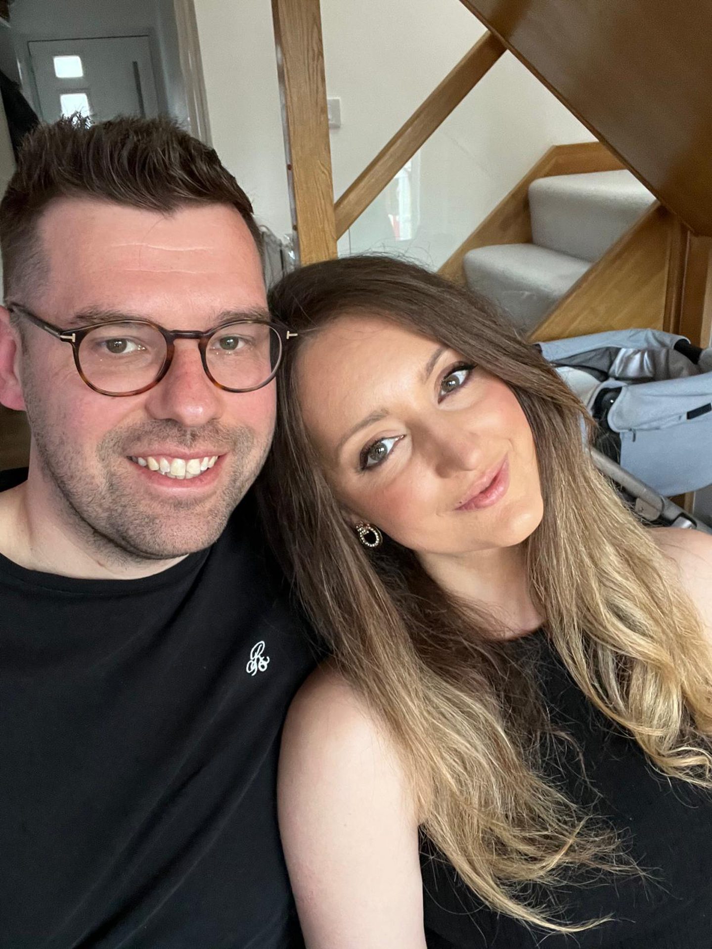 Young couple Alison and Daniel Smith who have completely renovated 123 Gray Street with the wooden and glass staircase behind.