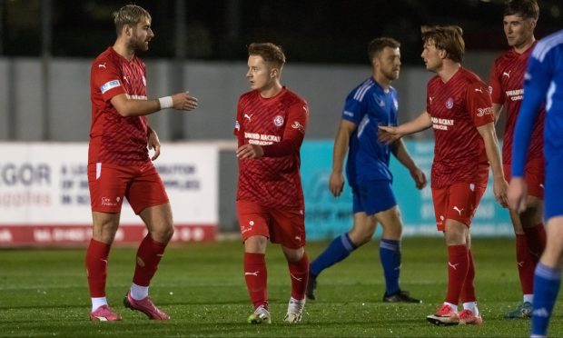 Inverurie Locos' Jamie Michie, left, and Ryan MacLeman, right, of Forres Mechanics battle for the ball