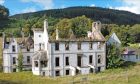 Wide view of the fire damaged Dunain House painted in white.