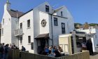 The popular Stromness hotel, with its bustling outdoor area