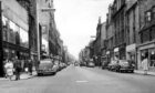 1964: A view along George Street in 1964 with each side lined with independent businesses. All the shops on the right were demolished to make way for the Norco (later John Lewis) building, and the buildings on the left were also flattened. Image: DC Thomson