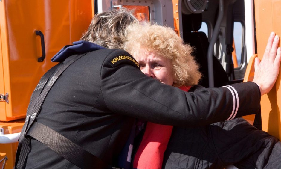 Jeannie is comforted during the emotional trip to the wreck in 2011.