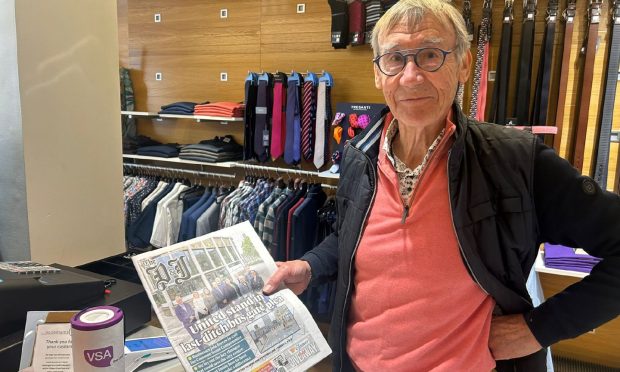 Norman Esslemont, who has launched a legal battle against the Aberdeen bus gates, holding The Press and Journal with the Common Sense Compromise front page.