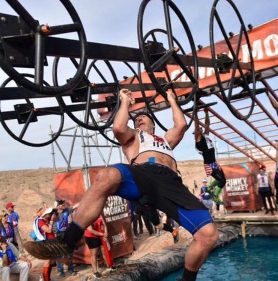 James Brown on monkey bars at Worlds Toughest Mudder in 2016