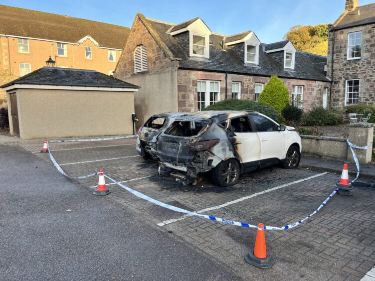 Burnt out cars within cordon