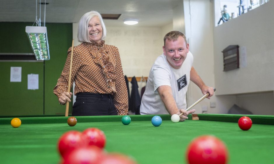 William Stewart and Gwen Jones at snooker table. 