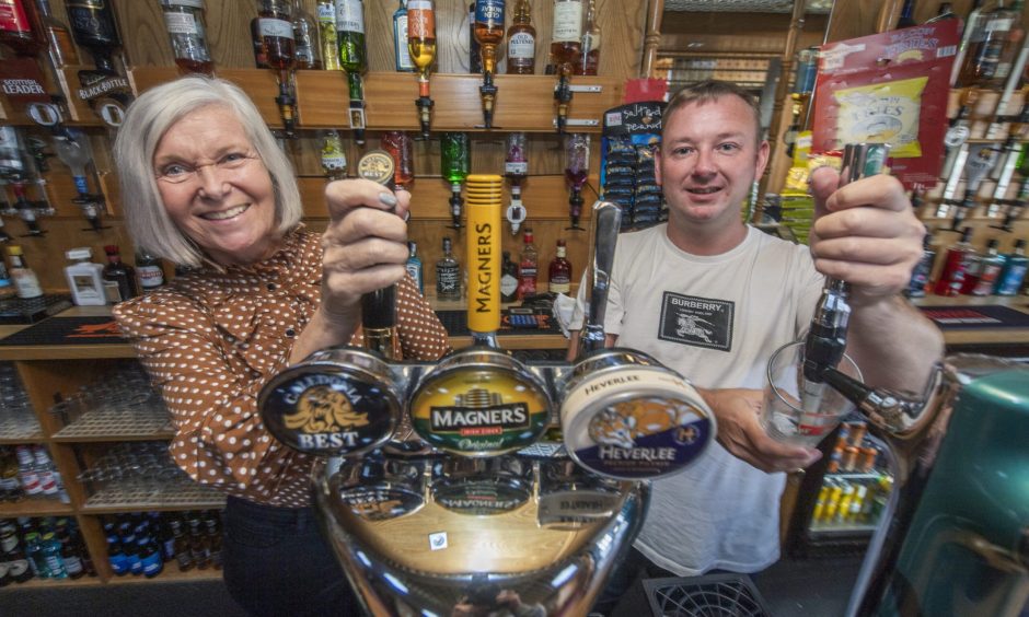 Gwen Jones and William Stewart behind the bar. 