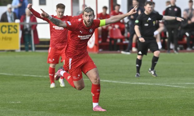 Inverurie Locos' Jamie Michie, left, and Ryan MacLeman, right, of Forres Mechanics battle for the ball