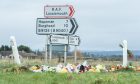 Flowers laid at the A941/B9135 junction where two teens were killed earlier this year. Image: DC Thomson.