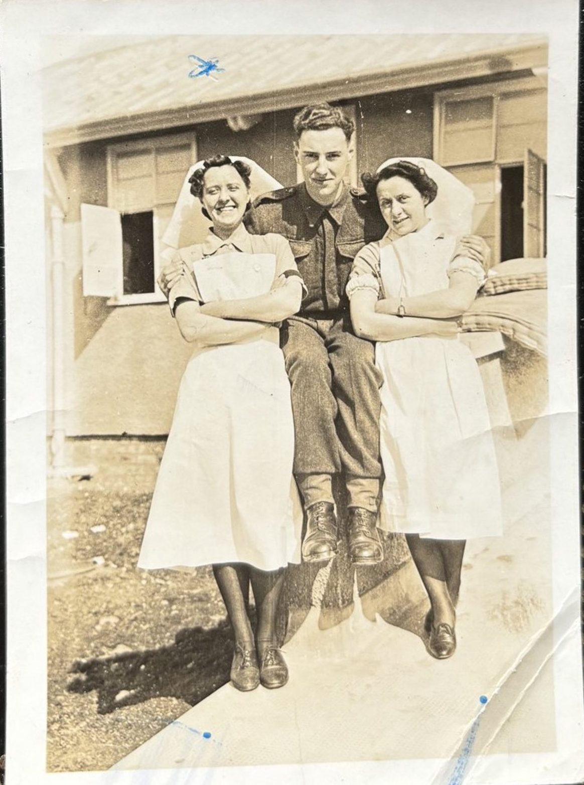 a nurse, a soldier and Nurse Jane Curran pose for a picture