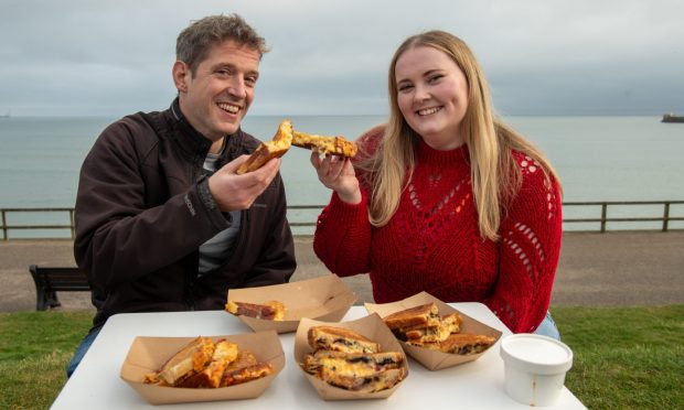 Food and drink journalist Joanna Bremner and Andy Morton try out the toasties from Croque on Aberdeen beach. Image: Kenny Elrick/DC Thomson