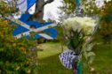 Floral tributes are being laid outside Alex Salmond's home in Strichen. Image: Kenny Elrick/DC Thomson