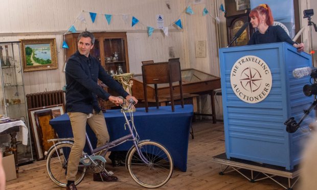 Travelling Auctioneer's Izzie Palmer and Robin Johnson. The latter is on a bike that was up for auction.